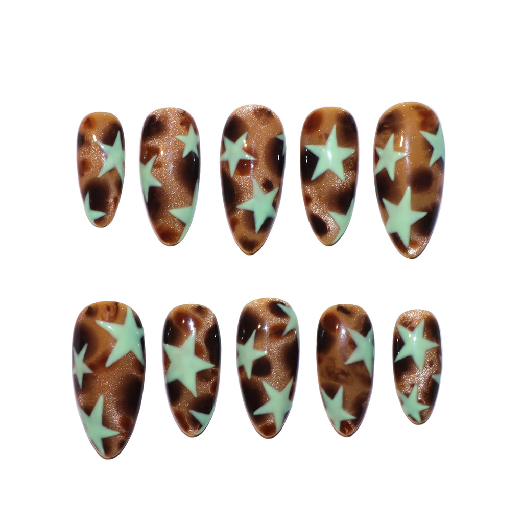 Ten almond-shaped press-on nails arranged in two rows on a plain white background. The nails feature a glossy brown and bronze marbled pattern with large mint green star designs.